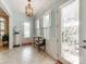 Elegant foyer with decorative glass doors, neutral paint, and decorative chandelier at 9730 White Frost Rd, Charlotte, NC 28277
