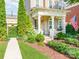 Charming home exterior featuring a covered porch, landscaped yard, and an American flag display at 9730 White Frost Rd, Charlotte, NC 28277