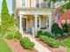 Charming home exterior featuring a covered porch, landscaped yard, and an American flag display at 9730 White Frost Rd, Charlotte, NC 28277