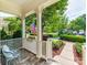 Inviting front porch with a chair, American flag, and view of the lush, landscaped front yard at 9730 White Frost Rd, Charlotte, NC 28277