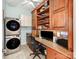 Laundry and utility room with front load washer/dryer, work desk, and ample storage at 9730 White Frost Rd, Charlotte, NC 28277
