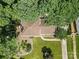 Aerial view of home with pristine lawn, mature trees, and a classic driveway and walkway layout at 1024 Regency Dr, Charlotte, NC 28211