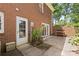 Brick patio perfect for outdoor gatherings with a door to the inside and a small garden at 1024 Regency Dr, Charlotte, NC 28211