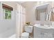 Traditional bathroom with a tub-shower combo, white vanity, floral shower curtain, and window at 1024 Regency Dr, Charlotte, NC 28211