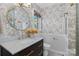 Charming bathroom features stylish wallpaper, a marble vanity top, and elegant gold fixtures at 1024 Regency Dr, Charlotte, NC 28211