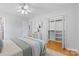 Bright bedroom boasting hardwood floors, a ceiling fan, and closet space at 1024 Regency Dr, Charlotte, NC 28211