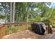 Wooden deck offers a relaxing outdoor space for entertaining with a view of the trees at 1024 Regency Dr, Charlotte, NC 28211