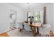 Bright dining room featuring a wooden table, modern chandelier, and classic white trim at 1024 Regency Dr, Charlotte, NC 28211