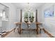 Bright dining area featuring paneled walls, chandelier, and a wooden table with seating for six at 1024 Regency Dr, Charlotte, NC 28211