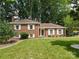 Charming brick home with white shutters, a well-manicured lawn, and classic curb appeal at 1024 Regency Dr, Charlotte, NC 28211