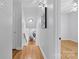 Inviting hallway features hardwood floors and leads to various rooms in the home at 1024 Regency Dr, Charlotte, NC 28211