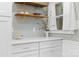 A lovely kitchen showcasing open shelving, white countertops, and gold fixtures at 1024 Regency Dr, Charlotte, NC 28211
