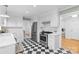 Charming kitchen with stainless appliances, white cabinets, and checkered flooring at 1024 Regency Dr, Charlotte, NC 28211