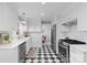 Modern kitchen with checkered floors, stainless appliances, and white cabinets at 1024 Regency Dr, Charlotte, NC 28211