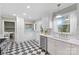 Bright kitchen with black and white checkered floors, stainless appliances, and white cabinetry at 1024 Regency Dr, Charlotte, NC 28211