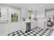 White kitchen featuring checkered floors, stainless dishwasher and white cabinets at 1024 Regency Dr, Charlotte, NC 28211