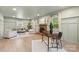 Stylish living room with a brick fireplace, neutral decor, and a separate desk area at 1024 Regency Dr, Charlotte, NC 28211