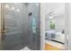 Modern shower showcases blue subway tile, a built-in niche, and glass door opening into bedroom at 1024 Regency Dr, Charlotte, NC 28211