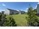 Spacious backyard with lush green grass, a black metal fence, and well maintained landscaping at 11031 Larkslea Ln, Charlotte, NC 28278