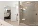 Modern bathroom featuring a glass shower and an open doorway to a bedroom at 11031 Larkslea Ln, Charlotte, NC 28278