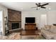 Comfortable living room offers stone fireplace and a large television at 11031 Larkslea Ln, Charlotte, NC 28278