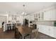 Open concept living space with dining area, kitchen island, and views of the modern kitchen at 11031 Larkslea Ln, Charlotte, NC 28278