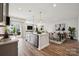 Open-concept living area with stainless steel appliances, kitchen island, and bright living room furniture at 1233 Margo Mannor Dr, Fort Mill, SC 29708