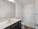 This bathroom features a dark vanity, a large mirror, and a shower and tub combo at 2532 Blue Moss Dr, Dallas, NC 28034