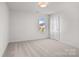 Bedroom featuring neutral walls, large window, and carpet flooring, providing an open, adaptable area at 2532 Blue Moss Dr, Dallas, NC 28034