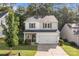 Charming two-story home featuring a two-car garage and a combination of stone and siding at 2532 Blue Moss Dr, Dallas, NC 28034