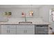 Open concept kitchen showcases a bar top with a stainless steel sink and dishwasher at 2532 Blue Moss Dr, Dallas, NC 28034