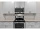 Modern kitchen features stainless steel oven/microwave and sleek countertops at 2532 Blue Moss Dr, Dallas, NC 28034