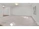 Spacious living room featuring neutral carpet, bright light from a window, and an entry doorway at 2532 Blue Moss Dr, Dallas, NC 28034
