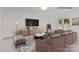 Virtually staged living room featuring a large sectional, area rug, and other decor at 2532 Blue Moss Dr, Dallas, NC 28034
