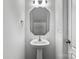 This powder room features a pedestal sink, modern lighting, and a large, stylish mirror at 2532 Blue Moss Dr, Dallas, NC 28034