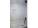 A bath and shower features white subway tiles, providing a clean aesthetic at 258 Lincoln Sw St, Concord, NC 28025