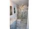 Bathroom featuring gray vanity with marble countertops, updated fixtures and marble shower at 258 Lincoln Sw St, Concord, NC 28025