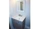 A bathroom features a vanity with marble countertop and stylish fixtures at 258 Lincoln Sw St, Concord, NC 28025