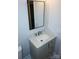Bright bathroom vanity featuring gray cabinets, a white marble countertop, and modern faucet at 258 Lincoln Sw St, Concord, NC 28025