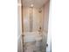 Clean bathroom with a tub shower featuring marble-style wall and floor tiles and modern fixtures at 258 Lincoln Sw St, Concord, NC 28025