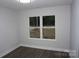 This bedroom has a large window, neutral paint and wood floors at 258 Lincoln Sw St, Concord, NC 28025