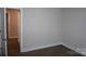 Neutral bedroom featuring modern floors, neutral walls, and a door to hallway at 258 Lincoln Sw St, Concord, NC 28025