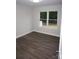 Bedroom featuring modern floors, neutral walls, and a view from two windows looking to the neighborhood at 258 Lincoln Sw St, Concord, NC 28025