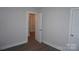 Clean bedroom featuring modern flooring, neutral walls, and doors to hallway and closet at 258 Lincoln Sw St, Concord, NC 28025