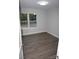 Bright bedroom featuring a window looking out onto the neighborhood, and modern floors at 258 Lincoln Sw St, Concord, NC 28025