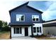 Charming two-story home featuring a modern two-tone exterior and a welcoming front porch at 258 Lincoln Sw St, Concord, NC 28025
