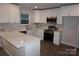Beautiful kitchen featuring white cabinetry, stainless steel appliances, and marble backsplash at 258 Lincoln Sw St, Concord, NC 28025