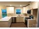 Well-lit kitchen featuring white cabinetry, stainless steel appliances, and attractive backsplash at 258 Lincoln Sw St, Concord, NC 28025