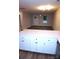 Bright open-concept living area featuring white cabinets and modern finishes at 258 Lincoln Sw St, Concord, NC 28025