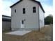 Exterior view of the home's rear showcasing the back door and a small patio area at 258 Lincoln Sw St, Concord, NC 28025